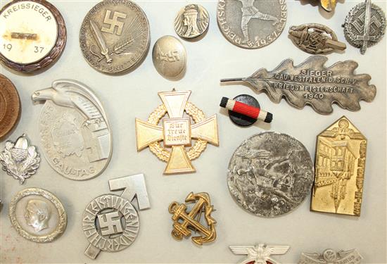 A large collection of various German Third Reich badges,